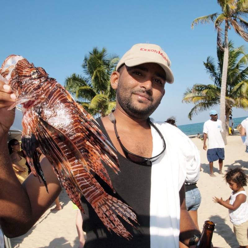 Tour company owner conrad holding a lionfish