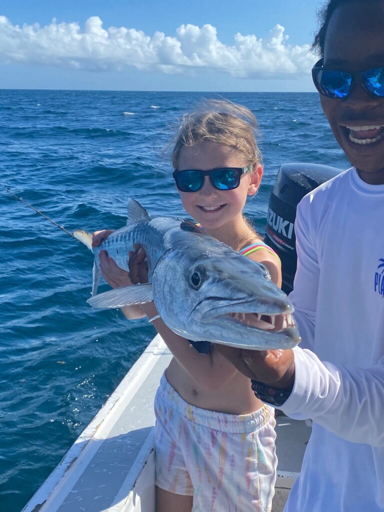 girl and guide with barracuda