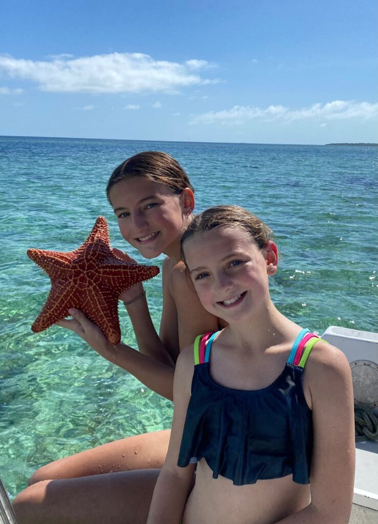 girls with seastar on snorkeling tour