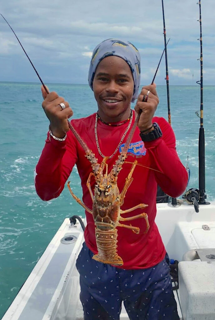 guide with lobster during season in belize