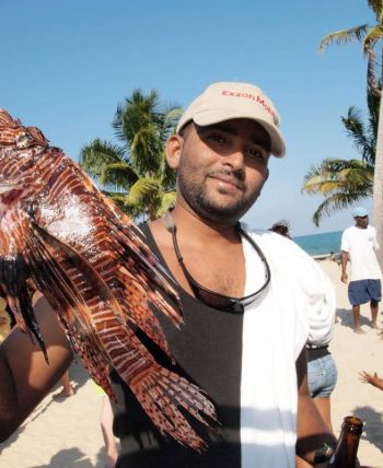 Tour company owner conrad holding a lionfish